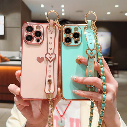 iPhone Phone Case - Dazzling Electroplated Solid Heart Accent, Stylish Heart-Shaped Wristband, Fashionable Diagonal Chain Shoulder Strap - Universally Compatible with iPhone 15, 14, 13, 12, 11 Pro, Promax, and Plus Models